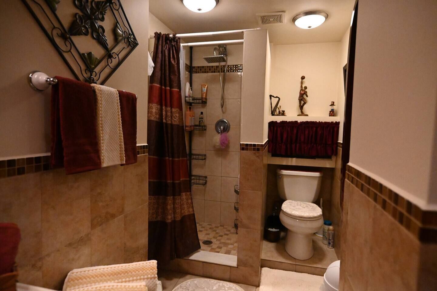 A bathroom with a shower, toilet, and sink.