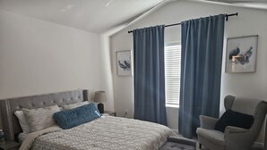 A bedroom with a bed, a chair, a window with curtains, a lamp, and a picture on the wall. - Family-Friendly 3BR Fast WiFi  10 Min to Uptown (Charlotte)