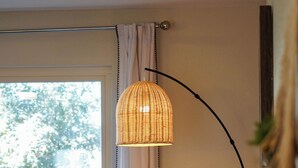 A room with a window, a lamp, a sofa, and a wall-mounted shelf. - Unique 4-bed, 3-bath house with Pool, Hot Tub, Arcade and Hi-Spd Wifi (Tempe)