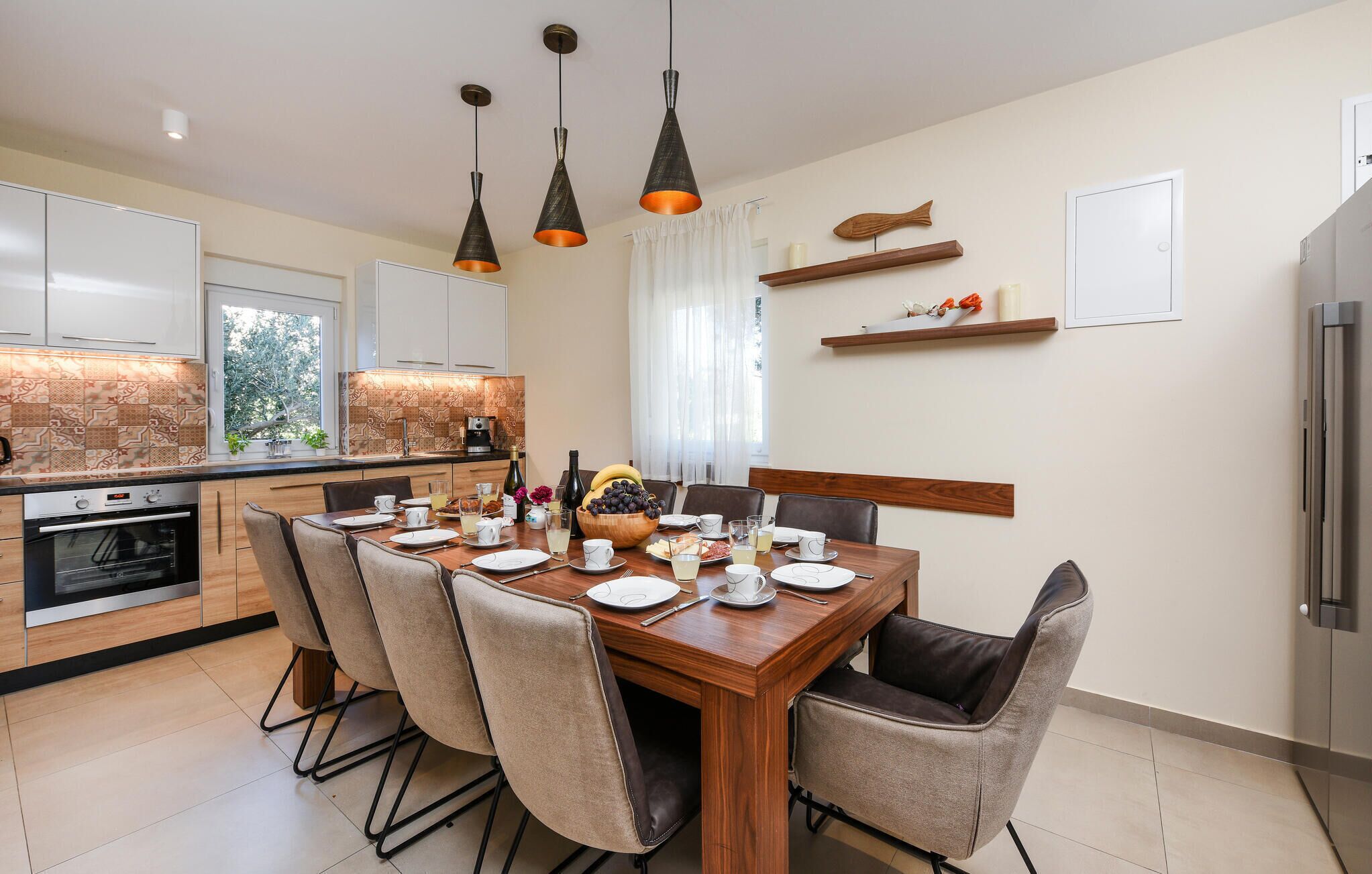 A modern kitchen with a dining area.