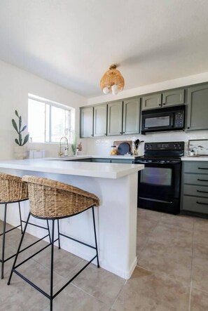 Fridge, coffee/tea maker, cookware/dishes/utensils