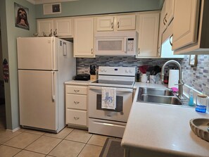 Microwave, oven, stovetop, dishwasher - The Crabby Condo has magnificent ocean views, steps to the boardwalk, and pool (Carolina Beach)