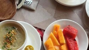 A plate with fried fish, rice, and a side of vegetables. - Casa Marta Hotel (Iloilo)