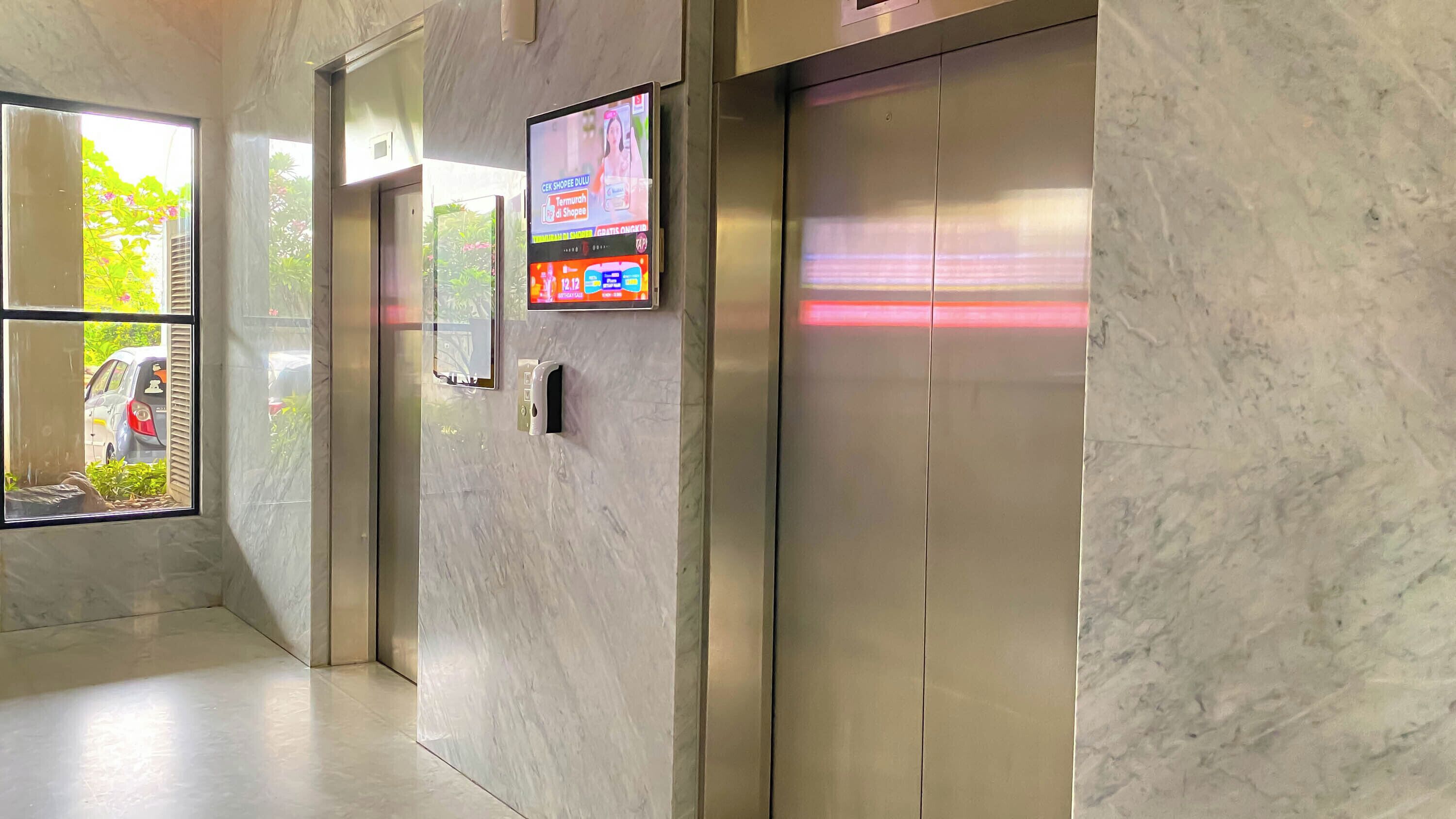 A modern elevator with a digital display and a keypad.