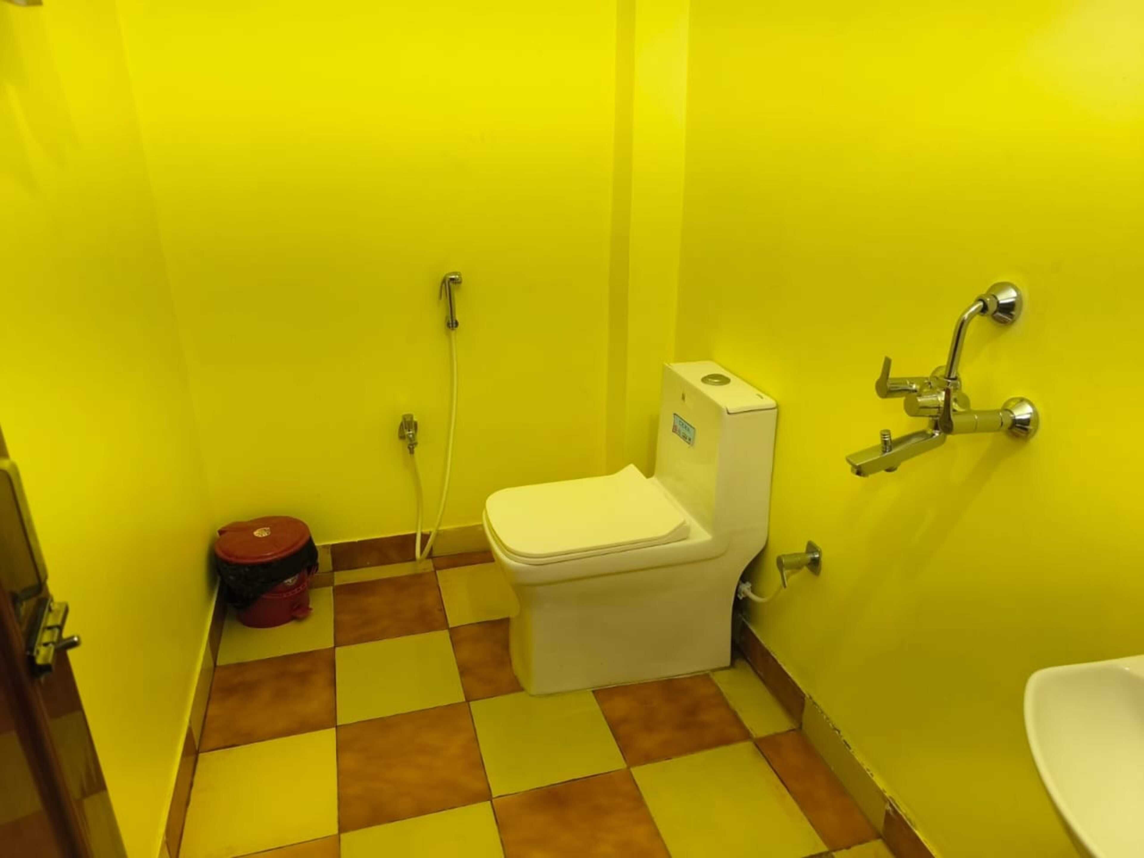 A small bathroom with a toilet, a bidet, and a sink.