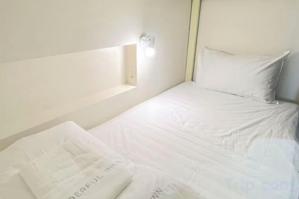 Premium bedding, laptop workspace, blackout curtains, soundproofing