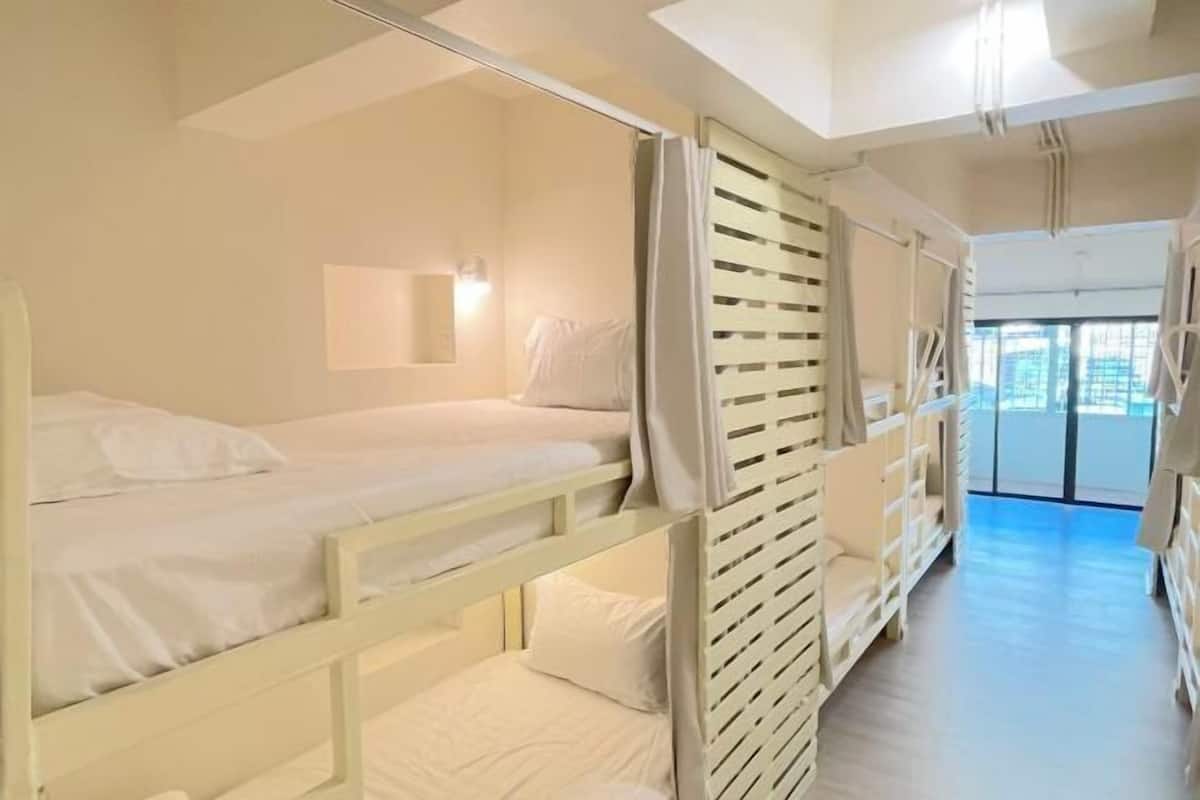 Premium bedding, laptop workspace, blackout curtains, soundproofing