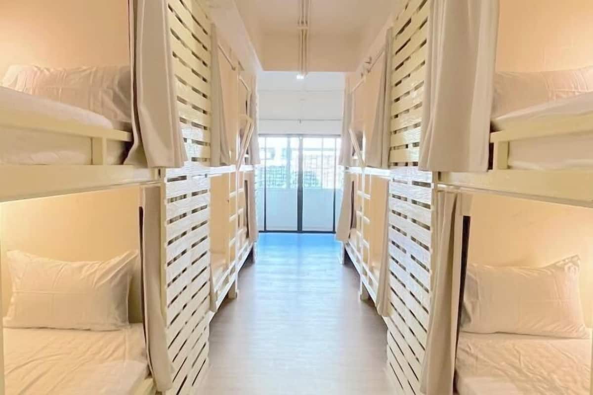 Premium bedding, laptop workspace, blackout curtains, soundproofing