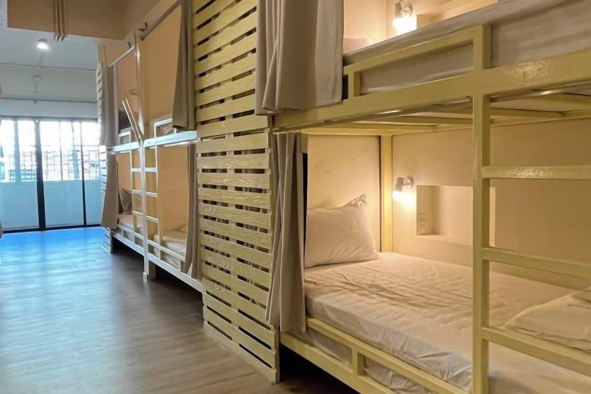 Premium bedding, laptop workspace, blackout curtains, soundproofing