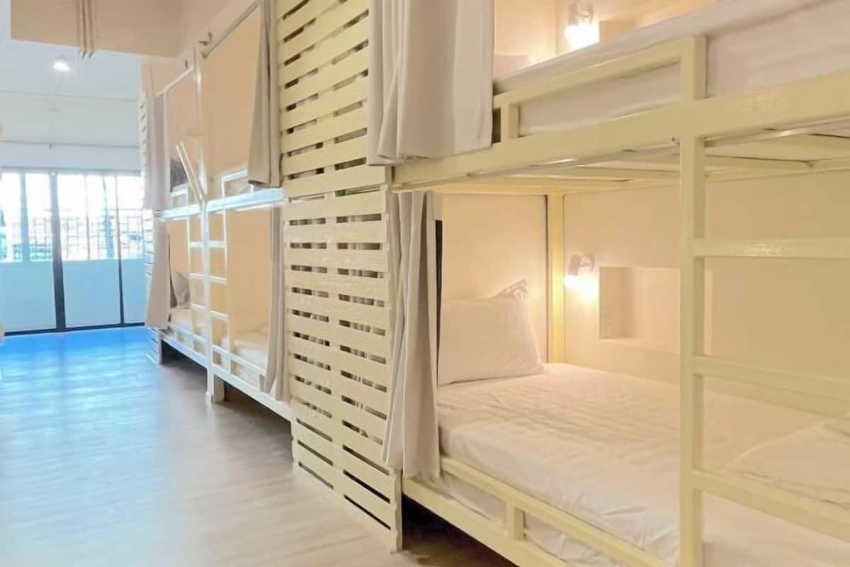 Premium bedding, laptop workspace, blackout curtains, soundproofing