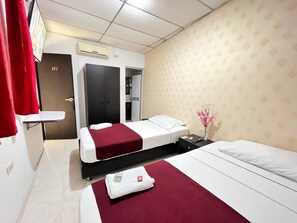A hotel room with two beds, a wardrobe, a bathroom, and a small desk. - Casa Dorada Hotel Boutique  (Neiva)