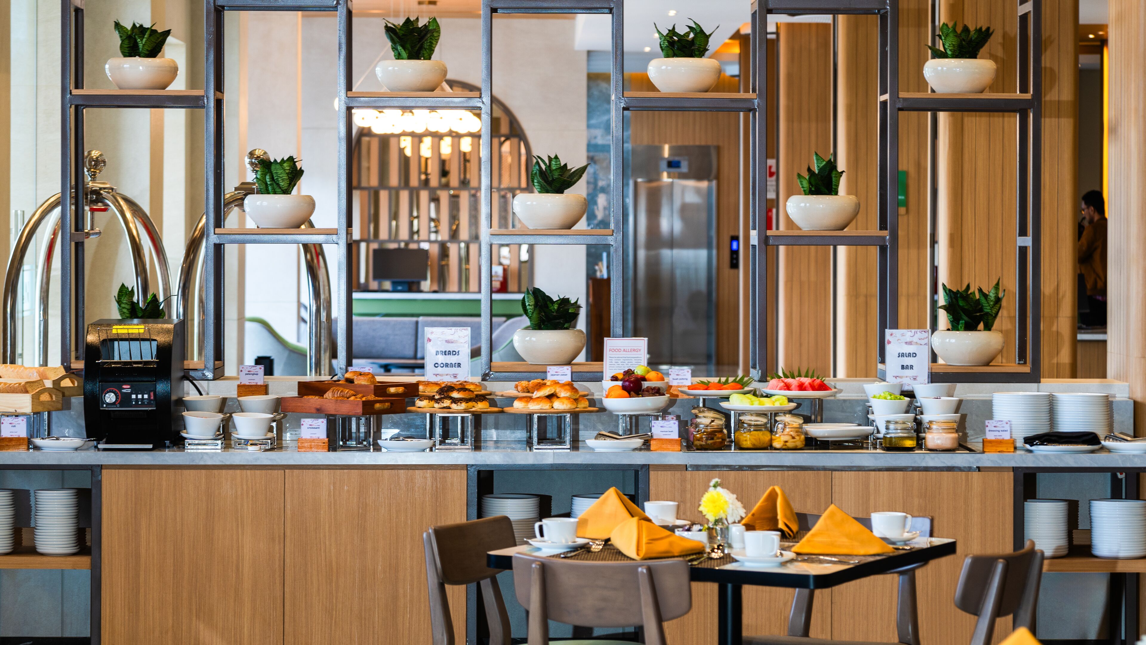 A buffet setup with various food items and a coffee machine.