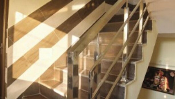 A staircase with glass railings and a black and white striped floor. - HR Rama Palace (Haridwar)