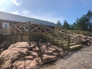 A wooden staircase leading to a building with a metal roof. - 4 Star Holiday Home in Backefors (Bäckefors)