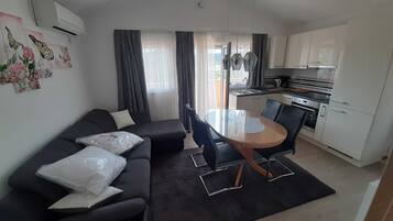 Apartment (Comfort Two Bedroom Apartment) | Living room | 32-inch flat-screen TV with satellite channels