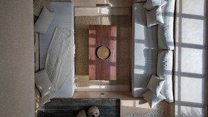 A modern living room with a sofa, a coffee table, and a rug. - Villa Alma at Bocoa Villas (Canggu)