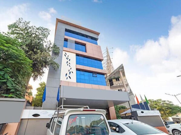 A multi-story building with a modern architectural design, featuring a mix of glass and concrete facades.