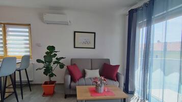 Apartment (Standard One Bedroom Apartment with S) | Living room | 32-inch flat-screen TV with cable channels