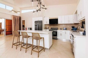 Fridge, stovetop, cookware/dishes/utensils, dining tables