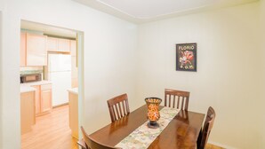 A dining area with a wooden table, chairs, and a decorative vase.