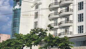 A hotel with a prominent 'HOTEL' sign, multiple balconies, and a modern facade. - Kinh Bac Hotel (Ho Chi Minh City)