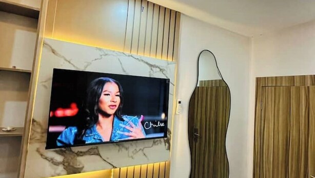 A television mounted on a wall with a marble-like design. - Studio(S9)@LEKKI PHASE 1, 24/7 Pwr by NgoZiLiving

 (Lekki)