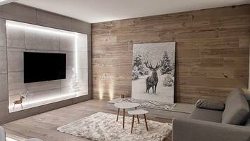 Suite Studio Deluxe, terrasse, vue montagne | Coin séjour | Télévision à écran plat de 40 pouces avec chaßnes numériques, cheminée