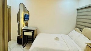 A bedroom with a bed, a desk, a chair, and a mirror. - Studio(S5)@LEKKI PHASE 1, 24/7 Pwr by NgoZiLiving

 (Lekki)