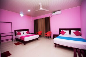 A hotel room with two beds, a ceiling fan, an air conditioning unit, and a window with curtains. - Bevary Guest (Anuradhapura)
