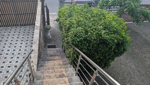 A set of stone steps with metal railings leading to a door. - GG Lodge (Mirissa)