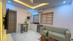 A modern living room with a sofa, a coffee table, and a TV. - 1Bed&Parlour(B4)@Lekki PH 1.24/7 Pwr By NgoZiLivin

 (Lekki)