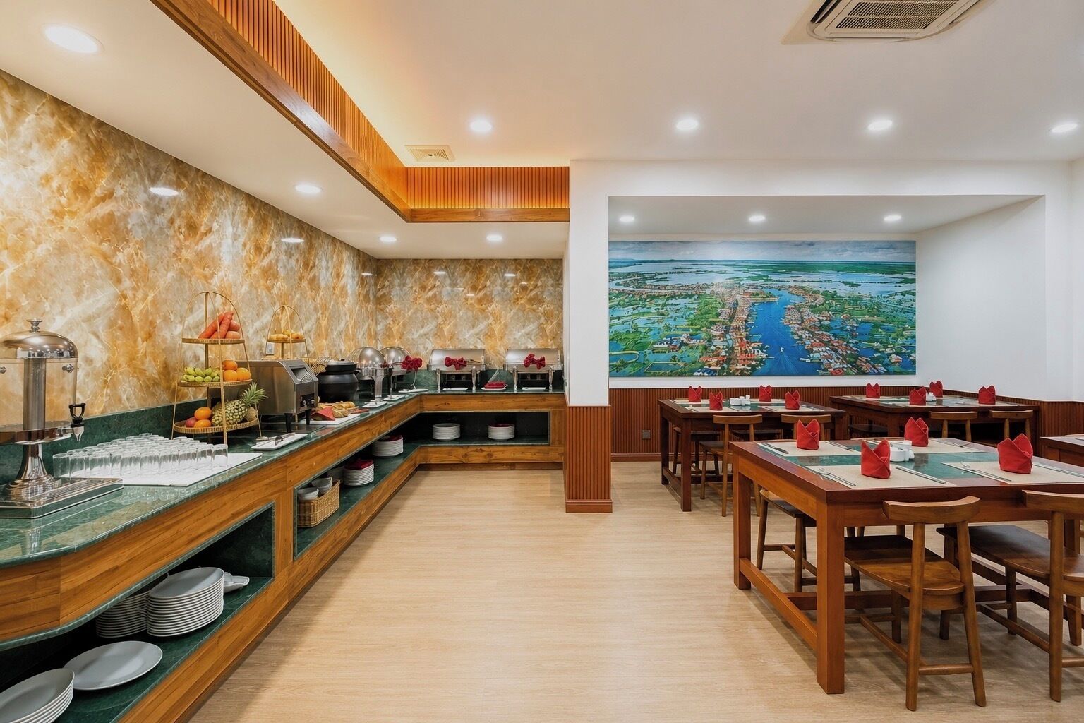 A restaurant with a buffet setup, wooden paneling, and a large painting of a landscape.