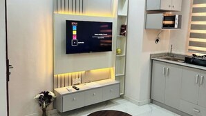 A modern kitchen with a built-in TV, a microwave, and a small cabinet. - 1Bed&Parlour(B3)@Lekki PH 1.24/7 Pwr By NgoZiLivin

 (Lekki)