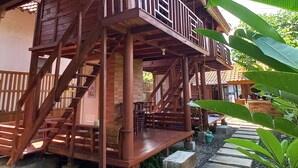 A wooden building with a balcony and stairs leading to a covered area. - Sandyakala Borobudur (Borobudur)