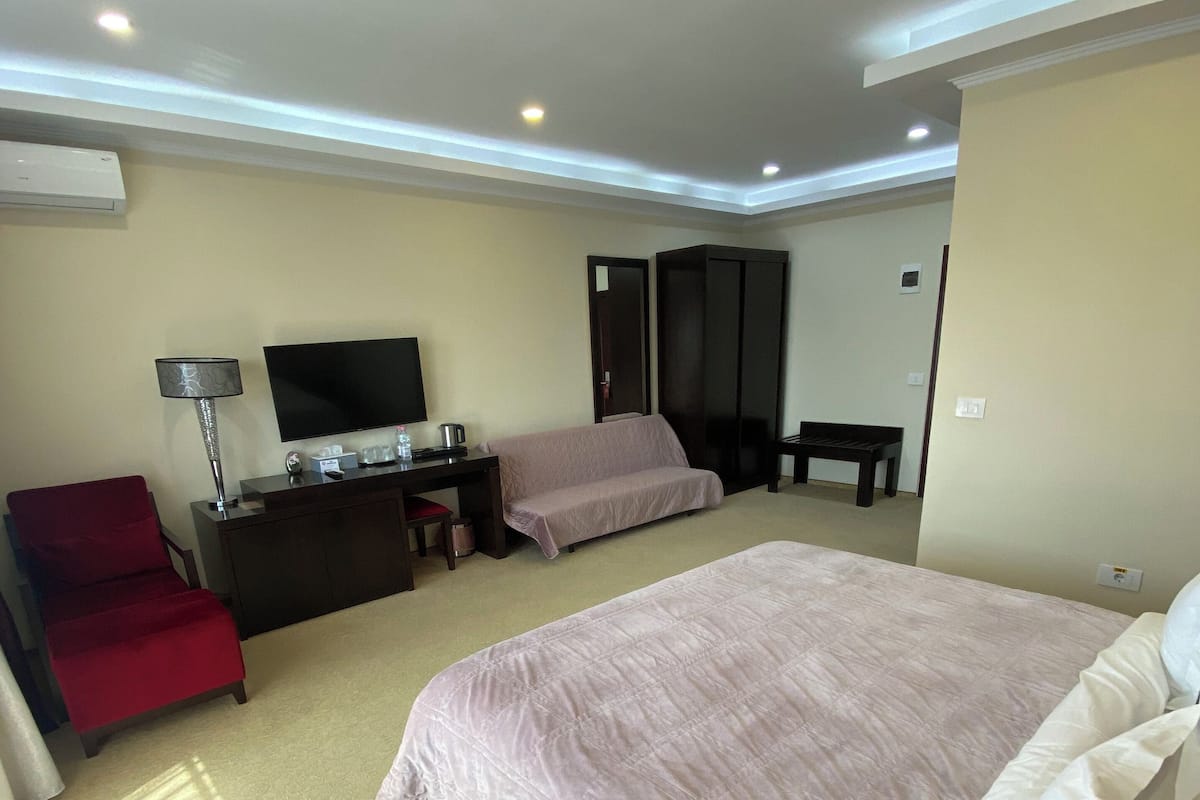 Deluxe Triple Room, Balcony, Garden View | In-room safe, desk, laptop workspace, soundproofing