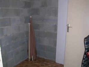 A cozy space with a door and a vertical object leaning against the wall.