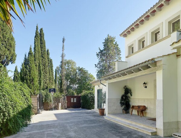 Relax in a serene courtyard surrounded by lush greenery and a tranquil atmosphere.