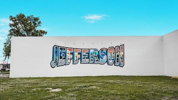 A white wall with the word "JEFFERSON" painted in colorful graffiti.