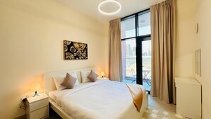 A hotel room with a large bed, a nightstand with a lamp, a window with curtains, and a city view. - Sunday Sheikh Zayed Road Concord Tower 1 BR by Belvilla (Dubai)