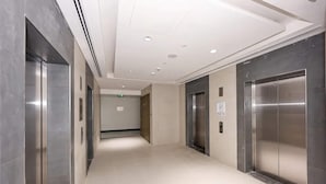 A modern elevator lobby with metallic walls and a clean, tiled floor. - Sunday Sheikh Zayed Road Concord Tower Studio by Belvilla (Dubai)