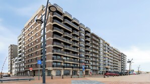 A multi-story apartment building with a uniform architectural style, featuring balconies on each floor. - Apartment in Blankenberge by the Sea (Blankenberge)