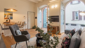A modern living room with a dining area, large windows, and a balcony. - The Printers Home 2 in Como (Como)