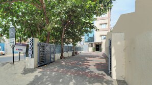A gated entrance to a building with a sign reading "ROOMS". - Hotel Krishna Residency  (Navi Mumbai)