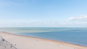 Una spiaggia ampia con cielo sereno e mare calmo.