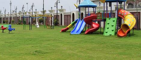 A playground with slides and a climbing structure.