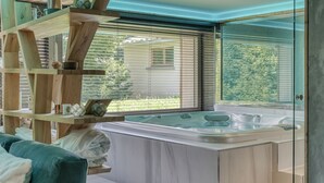 A modern bathroom with a large bathtub, wooden shelves, and a view of the outdoors. - LUXURY CHALET CLOSE TO THE VILLAGE (Megève)