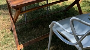 A wooden table set with breakfast items including a pitcher of pink smoothie, plates of eggs, toast, and fruit. - Amaly Pousada e Bistrô (Japaratinga)