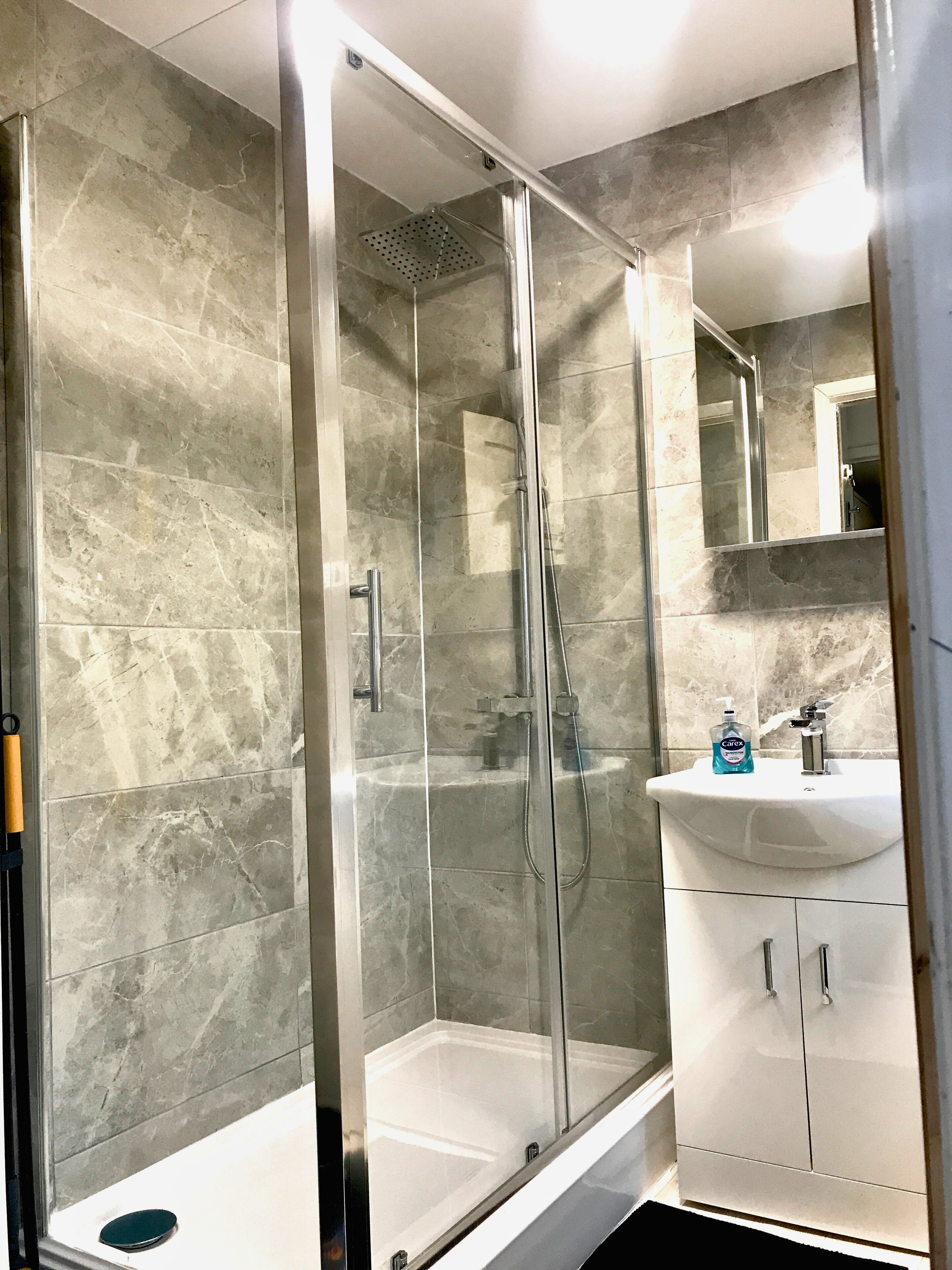 Shower, hair dryer, towels, toilet paper