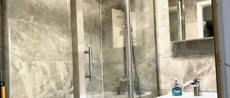 Shower, hair dryer, towels, toilet paper