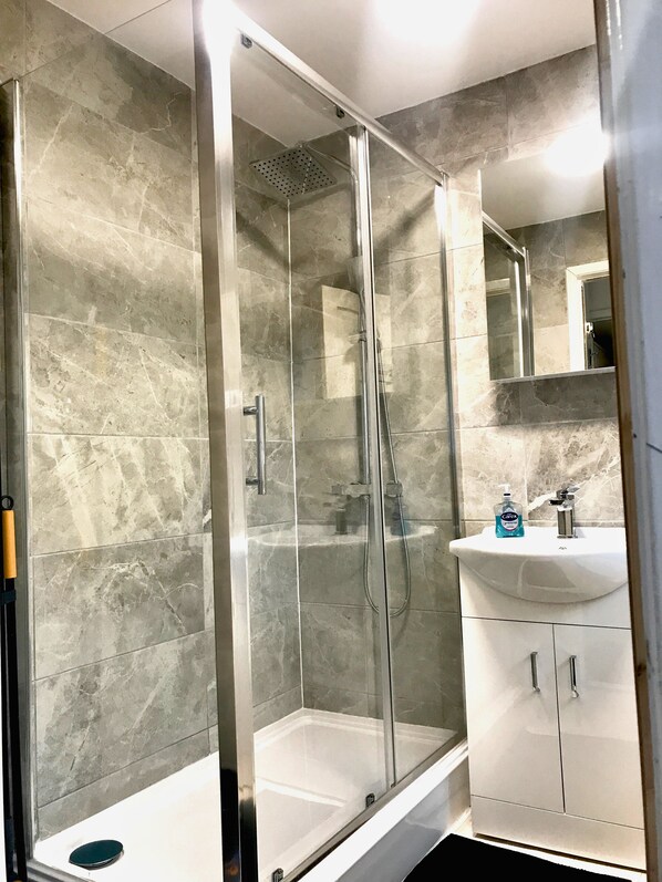 Shower, hair dryer, towels, toilet paper